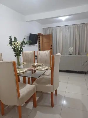 a living room with a table and chairs and a couch at Sunset Apartment Beach Residences Steps from the Beach in Puerto Plata