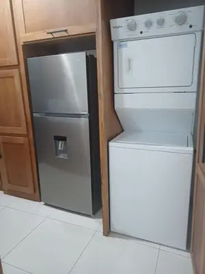 a kitchen with a refrigerator and a stove at Sunset Apartment Beach Residences Steps from the Beach in Puerto Plata