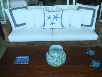 a white couch with pillows and a vase on a table at Apartment Balcones Del Atlantico in Las Terrenas