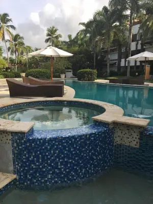 a large swimming pool with a blue tiled swimming poolvisor at Apartment Balcones Del Atlantico in Las Terrenas