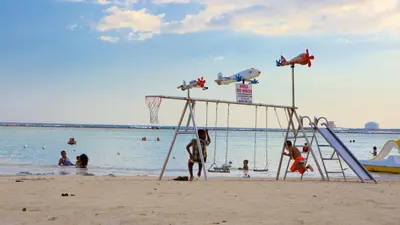 a group of people playing on the beach at Marvilla - Coastal Condo Poolside & Ocean View in Boca Chica