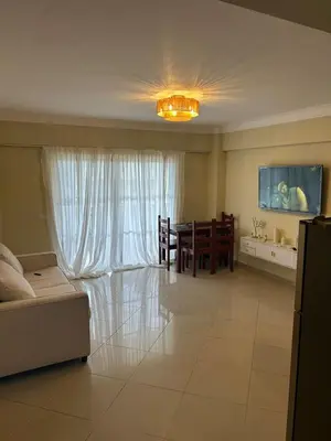 a living room with a couch and a dining room at Marvilla - Coastal Condo Poolside & Ocean View in Boca Chica