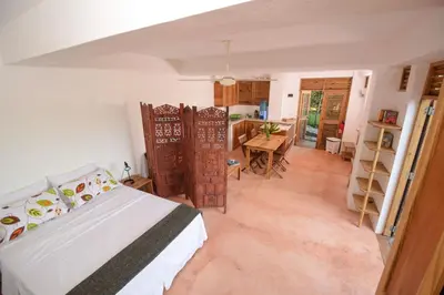 a bedroom with a bed and a table in it at Clave Verde Ecolodge in Las Terrenas