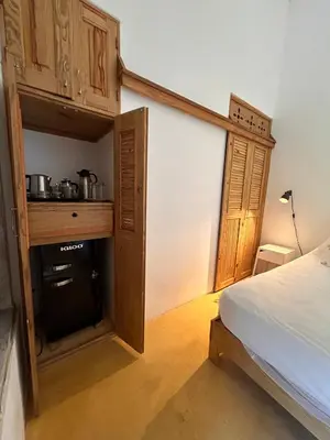 a bedroom with a bed and a stove in a room at Clave Verde Ecolodge in Las Terrenas