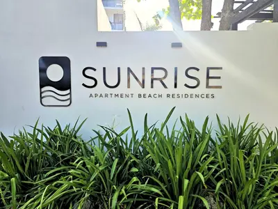 a sign for the sun rise apartment beach residences at Sunrise Apartments in San Felipe de Puerto Plata