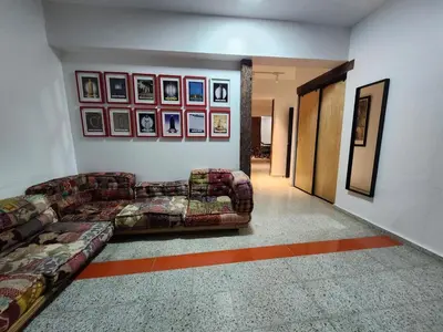 a living room with a couch and pictures on the wall at Apartment in Zona Colonial in Santo Domingo