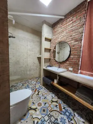 a bathroom with a brick wall and a sink and a tub at Apartment in Zona Colonial in Santo Domingo
