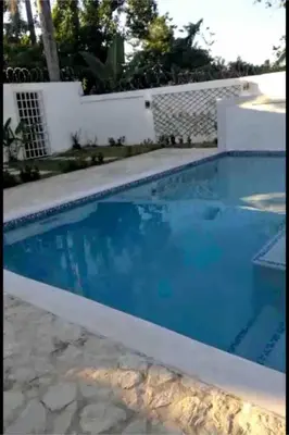 a swimming pool with blue water at Cheerfull 4 bedroom Villa with pool #VillaLioness in Nagua