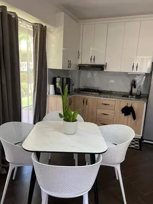 a kitchen with a table and chairs with a plant on it at Brisa de Mar in Boca Chica
