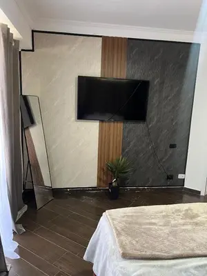 a bedroom with a flat screen tv on a wall at Brisa de Mar in Boca Chica