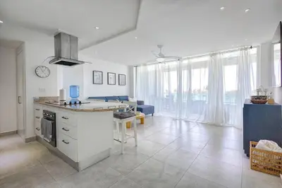 a kitchen and living room with a couch and a table at Apartamento En Marbella Vista Al Mar in Villas del Mar