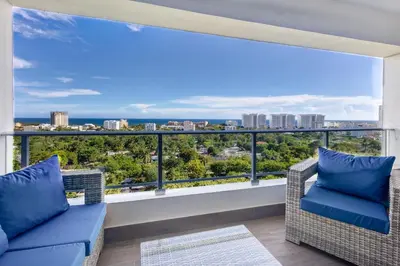 a balcony with a view of the city at Coralclifftower in Juan Dolio