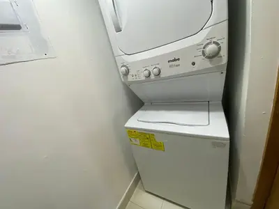 a fax machine sitting on top of a refrigerator at Maravilloso Descanso in Santo Domingo