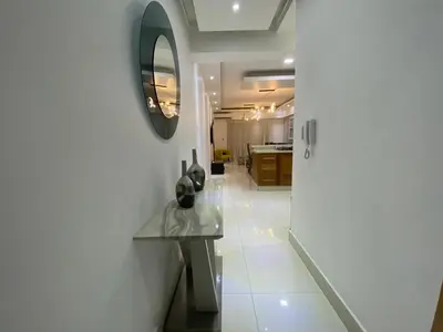 a kitchen with a table and a mirror on the wall at Maravilloso Descanso in Santo Domingo
