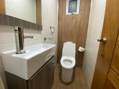 a bathroom with a white sink and a toilet at Maravilloso Descanso in Santo Domingo