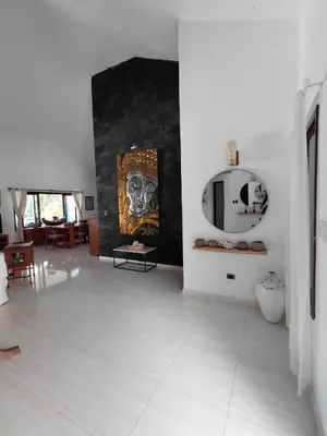 a living room with a painting of a dog on the wall at Villa Bali in Paraíso