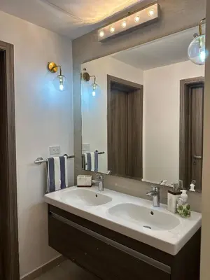 a bathroom with a sink and a large mirror at Relax in Style at Hard Rock Hotel Punta Cana Apartment in Punta Cana