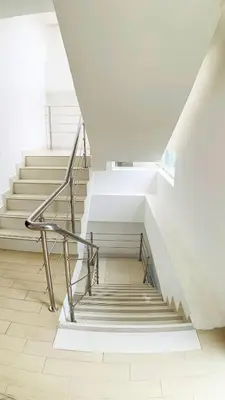 a staircase in a white building with a metal railing at Apartamento en Boca Chica T2 707 in Boca Chica