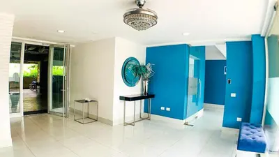 a room with blue walls and a vase on a table at Apartamento en Boca Chica T2 707 in Boca Chica