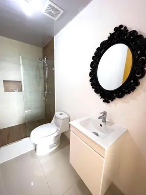a bathroom with a toilet and a sink and a mirror at Apartamento en Boca Chica T2 707 in Boca Chica