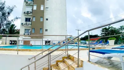 a swimming pool with a building in the background at Apartamento en Boca Chica T2 707 in Boca Chica