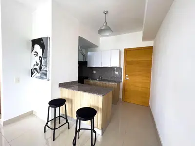 a kitchen with two bar stools and a counter at Apartamento en Boca Chica T2 707 in Boca Chica