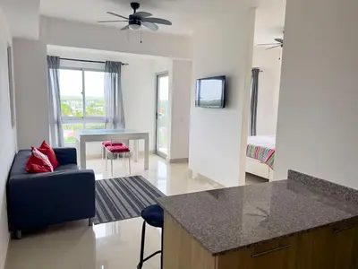 a kitchen and living room with a couch and a table at Apartamento en Boca Chica T2 707 in Boca Chica
