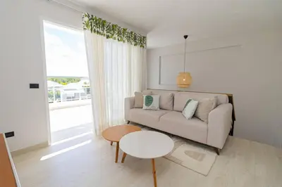 a living room with a couch and a table at Tropical 1BR Getaway in Dominicus Bayahibe - Garden Breeze