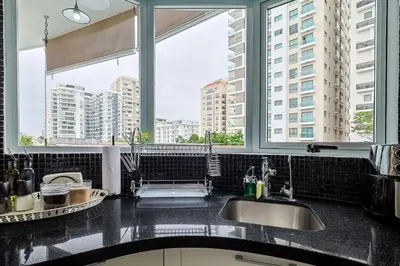 a kitchen with two sinks and two large windows at Comfy 1BR Apt, Centric Full AC in Santo Domingo