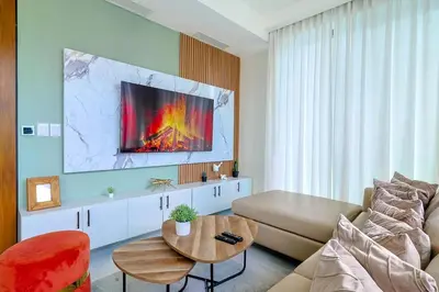 a living room with a couch and a table at Luxury Upscale Centric Condo, in Santo Domingo
