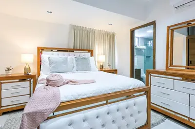 a bedroom with a bed and a large mirror at Spacious, 3BD City Center Apt in Santo Domingo