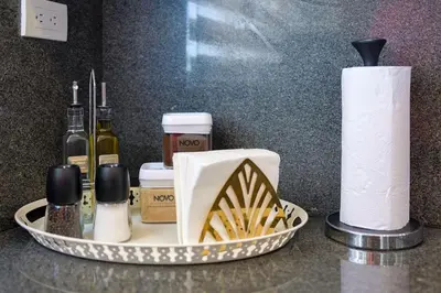 a tray with toilet paper and bottles of wine at Spacious, 3BD City Center Apt in Santo Domingo