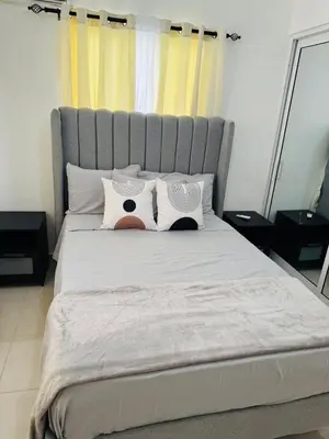 a bedroom with a large white bed with two pillows at Welcome Home 2 in Boca Canasta