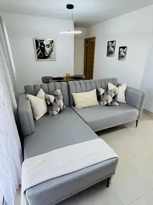 a gray couch with pillows in a living room at Welcome Home 2 in Boca Canasta