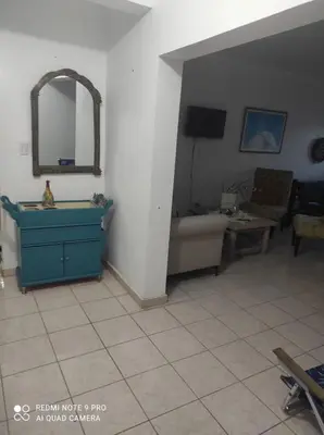 a living room with a blue dresser and a couch at Sweet beach apartment in San Felipe de Puerto Plata