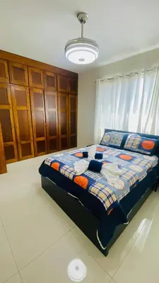 a bedroom with a bed with a quilt on it at Charming Apartment in Jarabacoa with Shared Pool in Jarabacoa