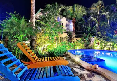 a swimming pool with two lounge chairs next to a swimming pool at Lux Garden Loft close to Beach, Kite-school in Cabarete
