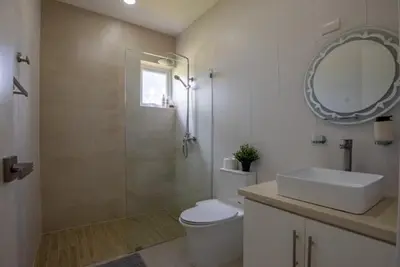 a bathroom with a toilet and a sink and a mirror at Sosua Ocean Village Villa 24 in Sosúa