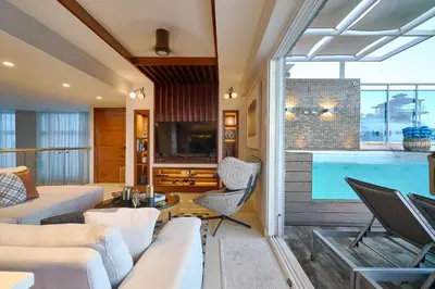 a living room with a large swimming pool at Acqualina’s View @ Santo Domingo in Santo Domingo