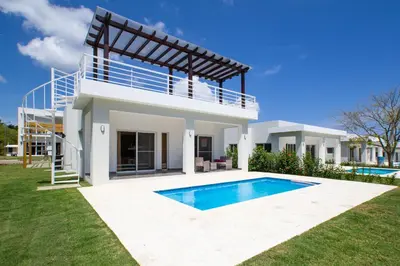 a villa with a swimming pool and a house at 2 bedrooms Villa 16 at Villas Tisu in Sosúa