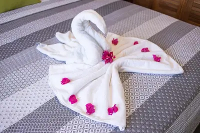 a white towel with pink hearts on a bed at 2 bedrooms Villa 16 at Villas Tisu in Sosúa