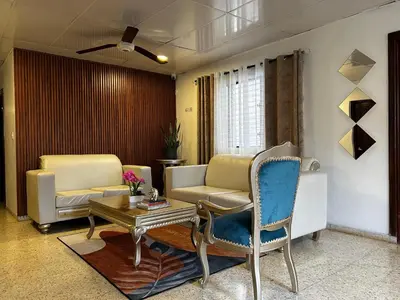 a living room with two chairs and a table at Dominico Colonial in Santo Domingo