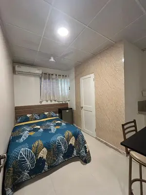 a bedroom with a bed with a blue comforter at Dominico Colonial in Santo Domingo