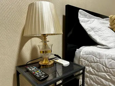 a lamp on a table next to a bed at Dominico Colonial in Santo Domingo