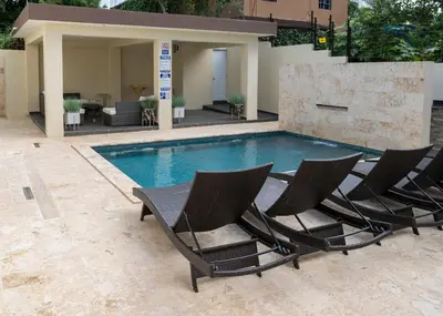 a group of chairs sitting next to a swimming pool at La Isla Royal - Marea Estelar in Miches