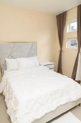 a bedroom with a white bed and a window at La Isla Royal - Marea Estelar in Miches