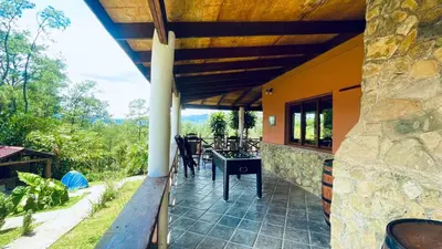 a porch of a house with a table and chairs at Luxury Villa Heated Pool, Firepit & Pool Table in Arroyo Frío