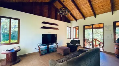 a living room with a couch and a flat screen tv at Luxury Villa Heated Pool, Firepit & Pool Table in Arroyo Frío