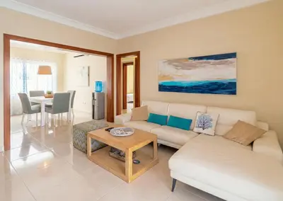 a living room with a couch and a table at Stylish Punta Cana Apartment - Eden Caribe in Punta Cana