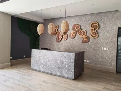 a lobby with a reception desk and hanging baskets at Apt in luxurious condominium near the beach in Juan Dolio